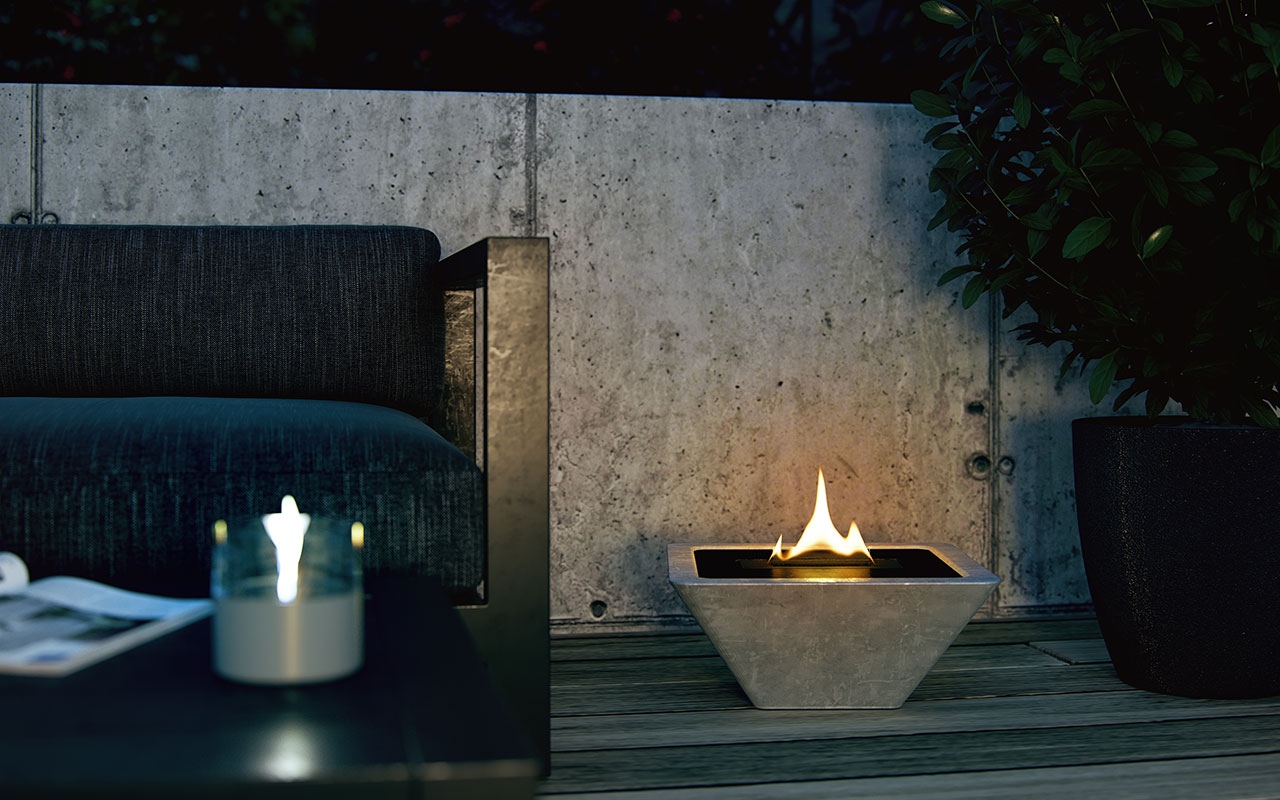 Stämningsfull låga En omvänd pyramidformad tenderflame kamin ute på verandan i mörkret