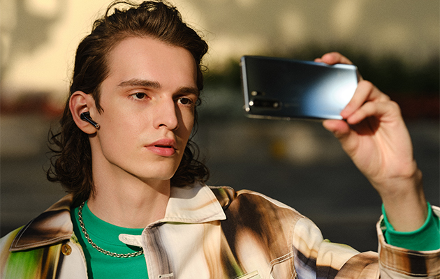 Huawei FreeBuds 3i tar bort oönskat brus Man med mobiltelefon och Huawei FreeBuds 3i