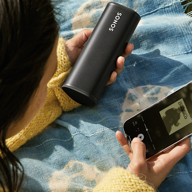 Få bättre kontroll med Sonos-appen Sonos Roam på picknik-filt med mobil
