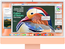 Orange iMac sedd framifrån, skärmen visar en bildredigeringsapp med AI-verktyg och i bakgrunden syns appen Mail