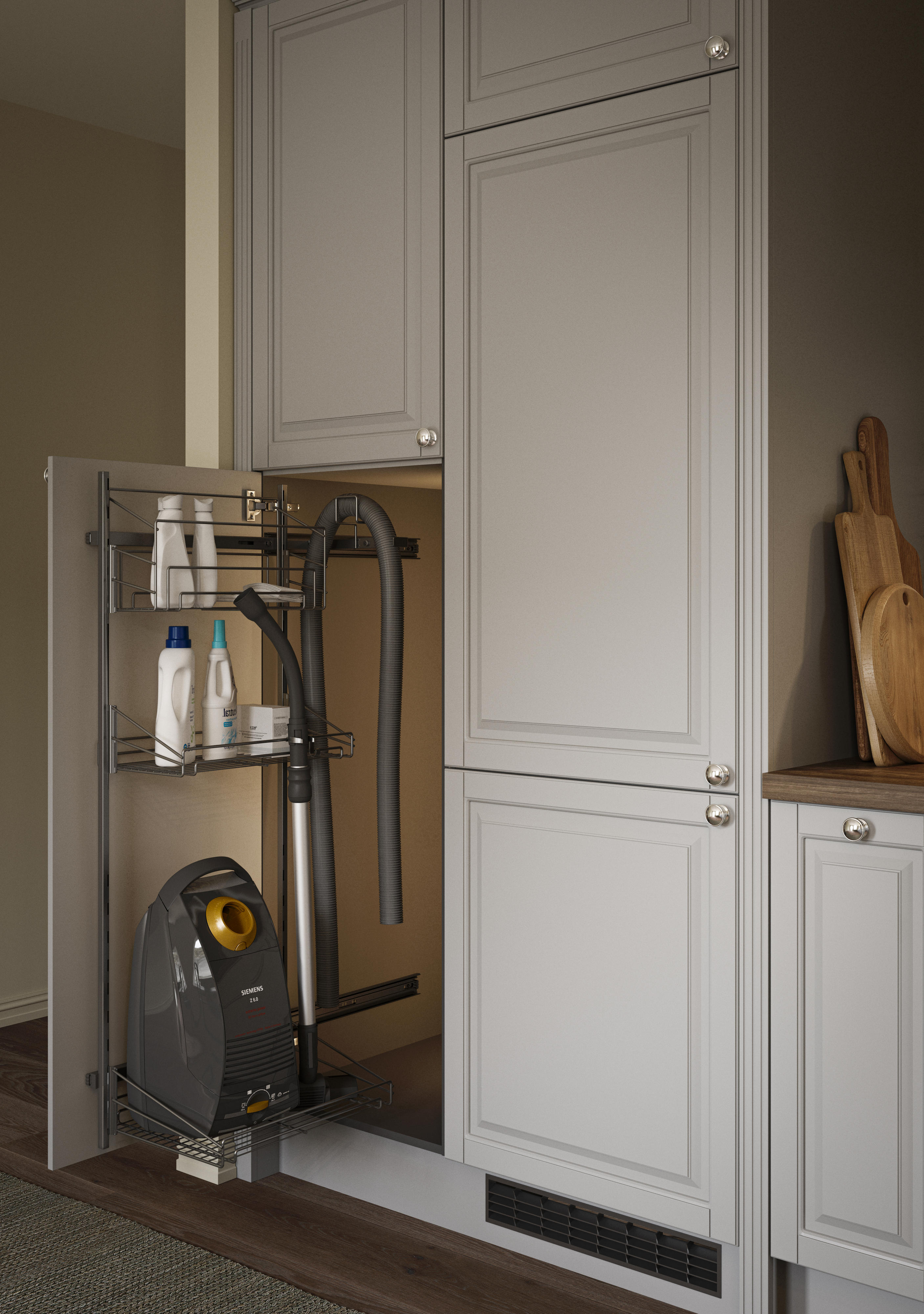 An open door with a pull-out solution holding a vacuum and detergents in an Epoq Heritage Light Grey kitchen