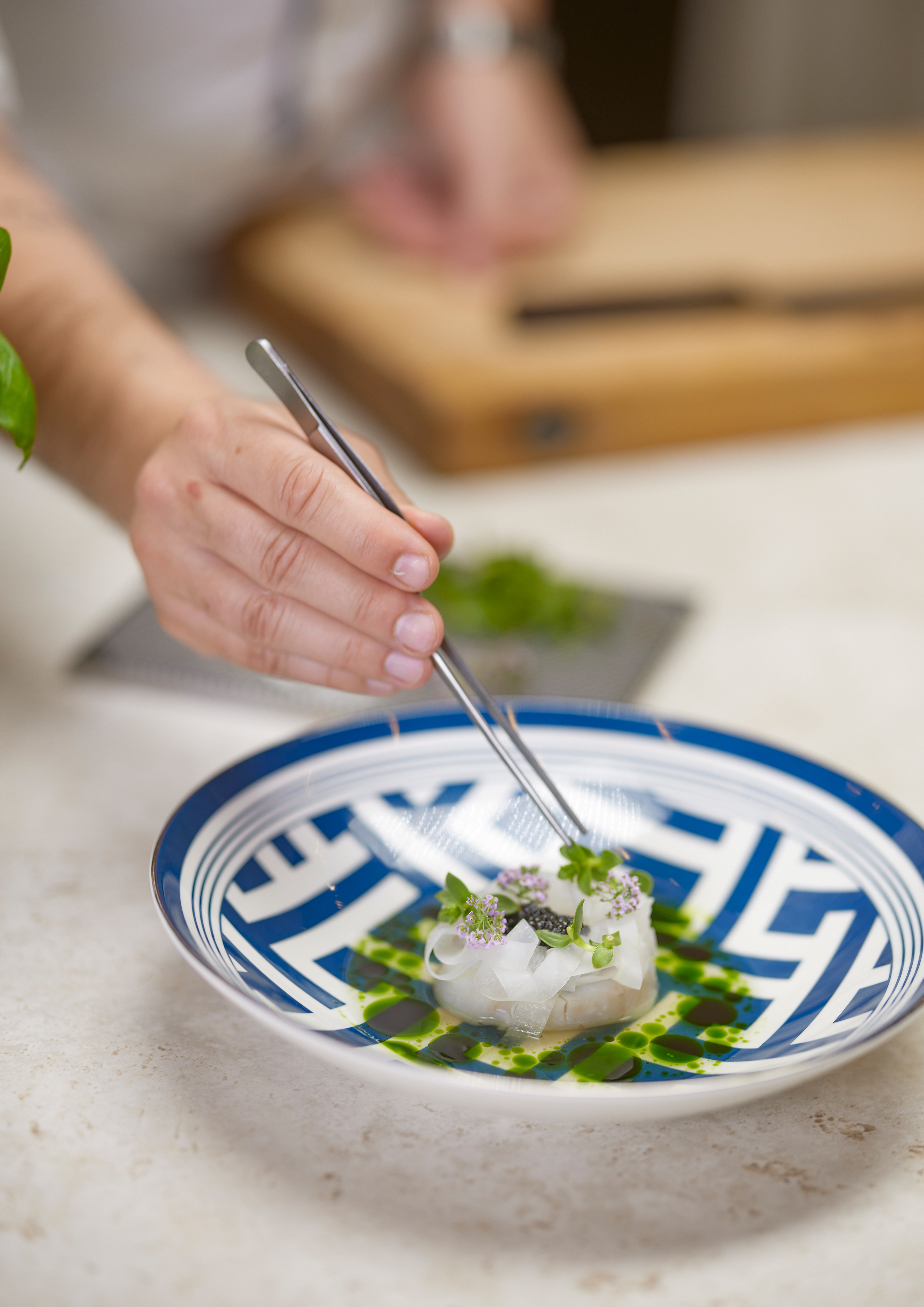 Fish that has ben steamed in a Bosch accent line oven is being decorated with herbs