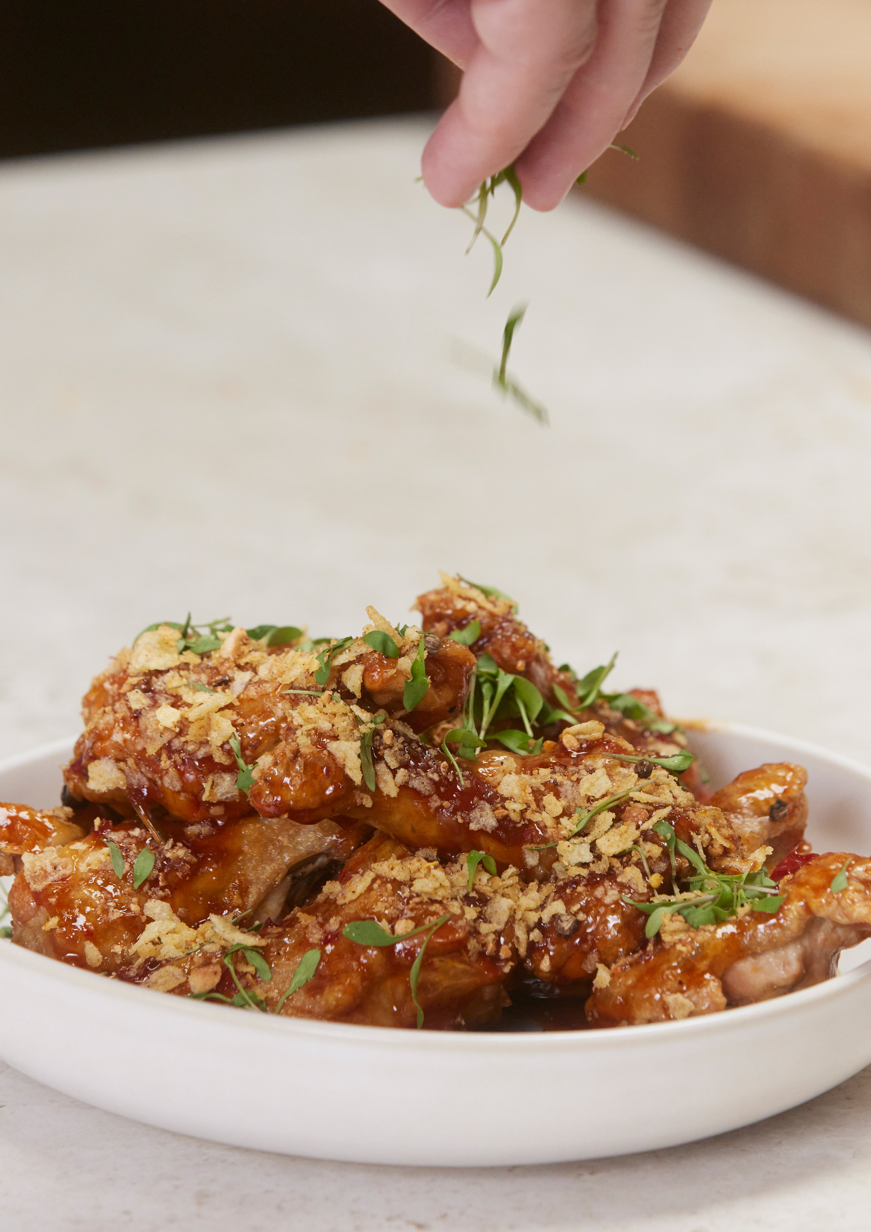 Fried chicken that has been airfried to perfection in a Bosch accent line oven is garnished with herbs