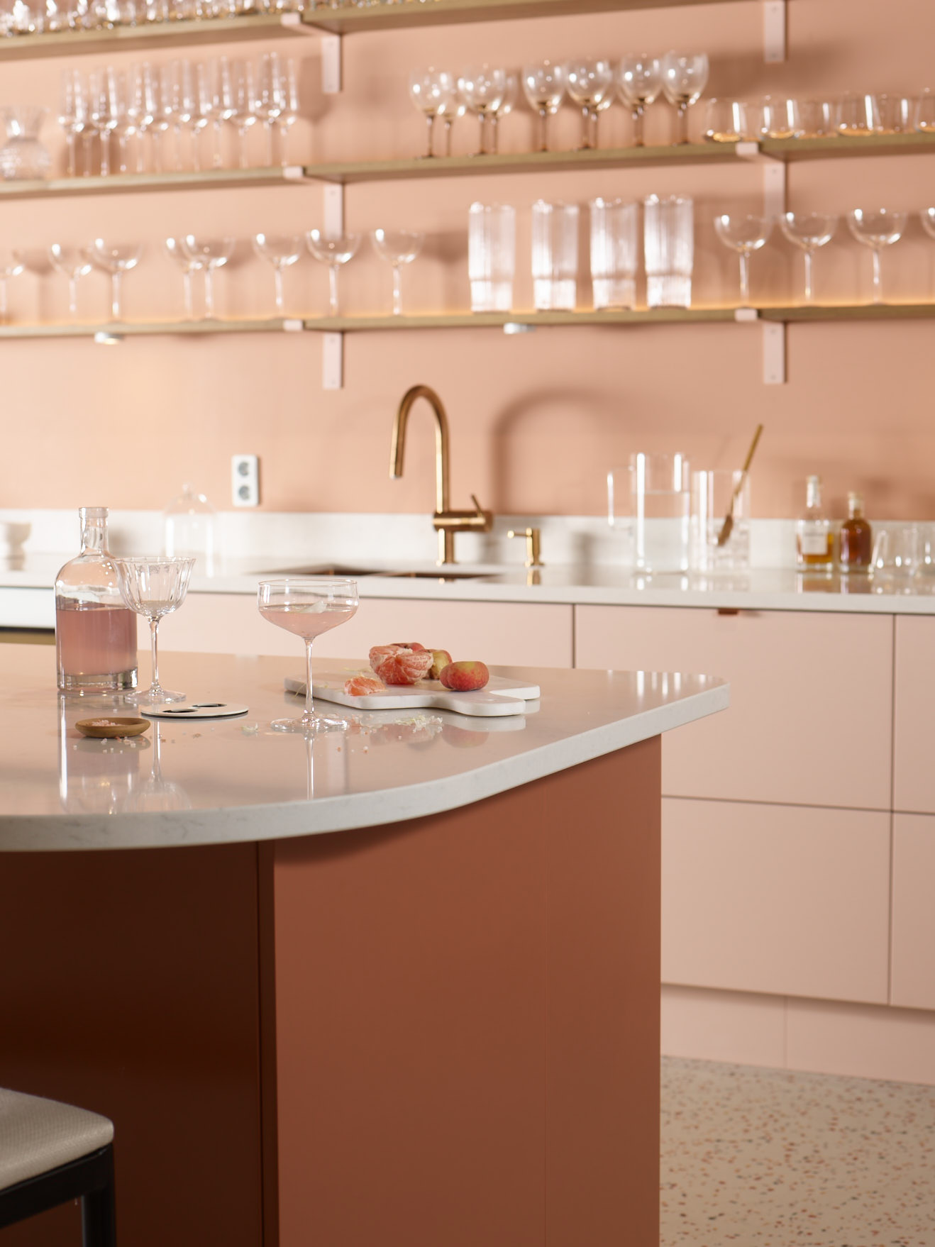 Trend blush colored kitchen and glasses on a shelf