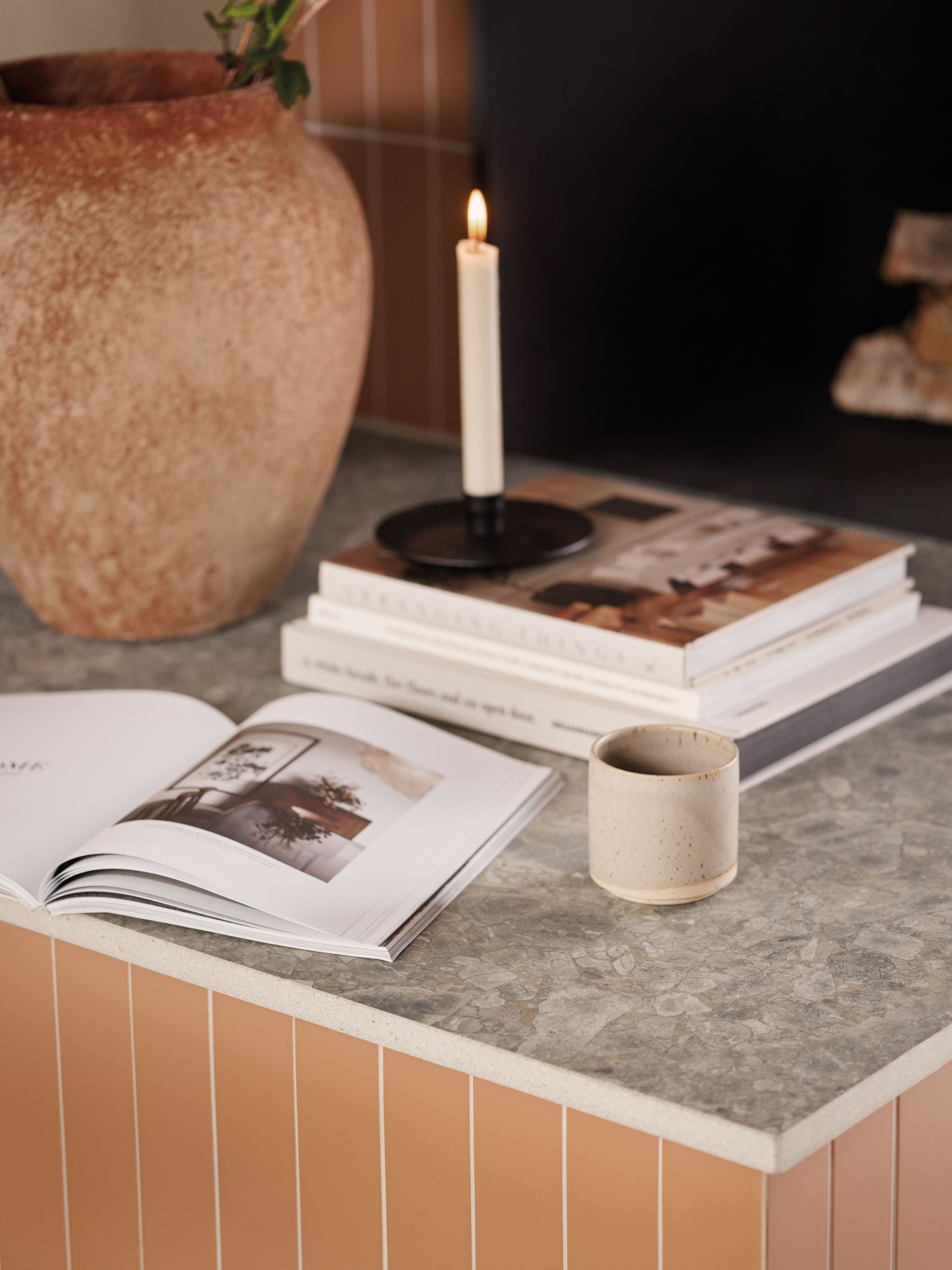 EPOQ - Japandi - Detail picture of candle, books and a fireplace