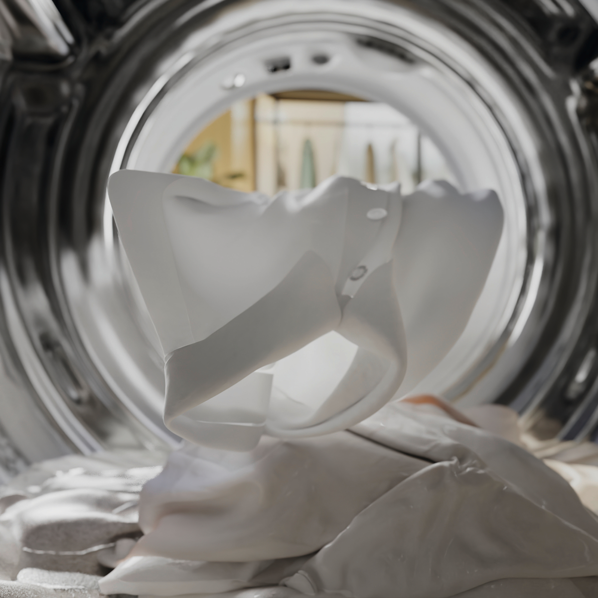 Picture from inside Miele washing machine drum with white laundry in it