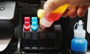 Refilling ink cartridges in printer with ink bottle