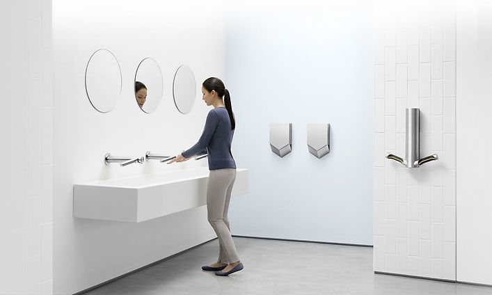 Dyson Airblade handtork på en vit offentlig toalett.
