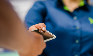 Corporate - Sustainabillity - customer handing over a phone