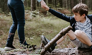 Corporate - Social responsibility - Kid being helped in the woods