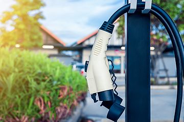 An EV-charger hanging in front of a house