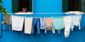 MDA - Clothes hanging on a line with a blue wall in the background