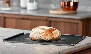 Bread on baking sheet in a kitchen