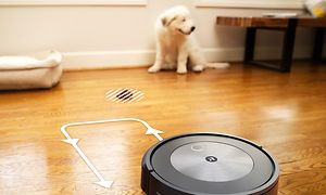 iRobot i vardagsrum med illustration som visar avståndsmätning. En hund sitter i bakgrunden.