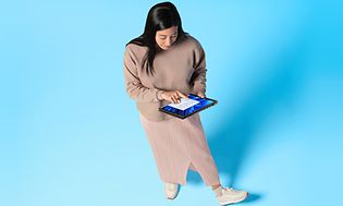 Woman holding Windows 11 laptop