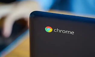 öppen Chromebook på ett bord framför en person