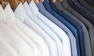 Shirts in different colours hanging in a row