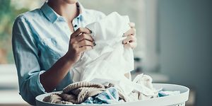 Woman folding laundry from a laundry basket