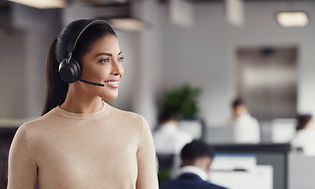 Woman with headset on in office