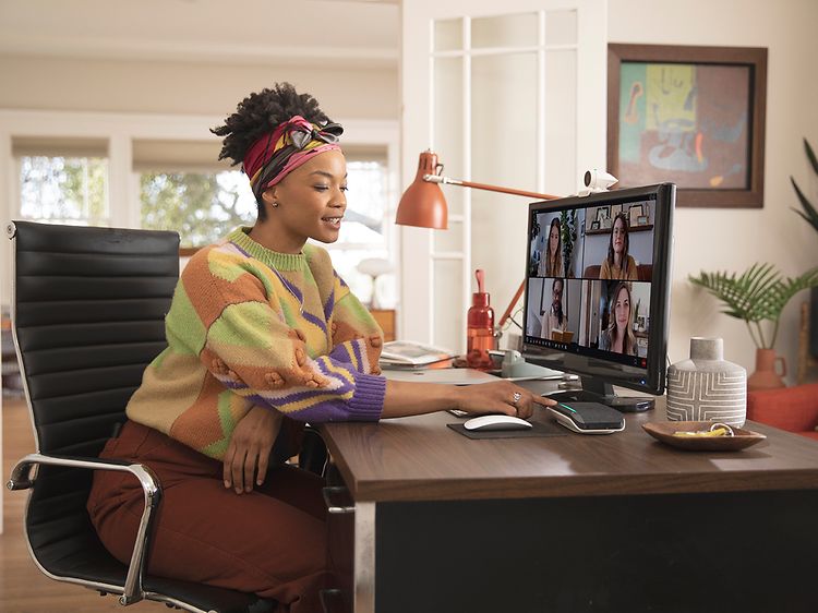 Woman attending a video meeting at home office