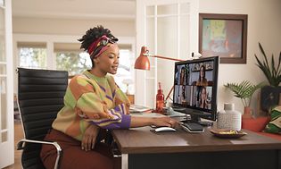 Woman attending a video meeting at home office