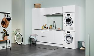 White EPOQ Gloss white laundry room in an open utility room solution, with washing machine and tumble dryer