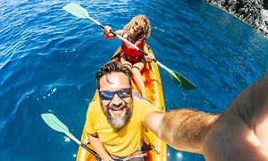 Par i en kanot som tar en selfie med en actionkamera