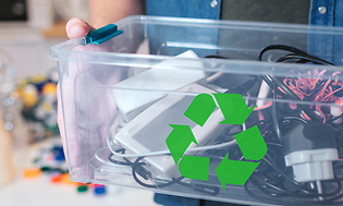 Sustainability - Recycling - A man holding a box with old electronics and a recycle logo