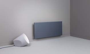 Black smart heater on a grey wall 