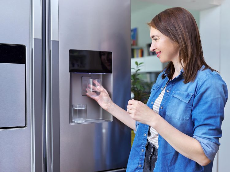 MDA-Fridges-Fridge with ice machine-Woman getting ice in glass from the fridge