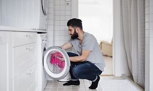 MDA-Whitegoods-Man loading washing machine