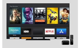 Startbild från Apple TV med olika filmer, Netflix logga och HBO med mera.