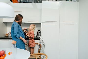 MDA-Fridges-Pregnant woman and little girl standing in a kicthen