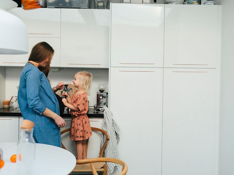 MDA-Fridges-Pregnant woman and little girl standing in a kicthen