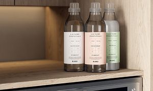 Detergent bottles on a washing machine from Asko