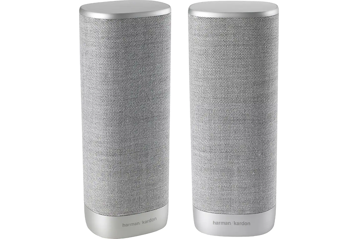 Två stycken gråa cylinderformade högtalare på högkant av märket Harman Kardon Citation. 