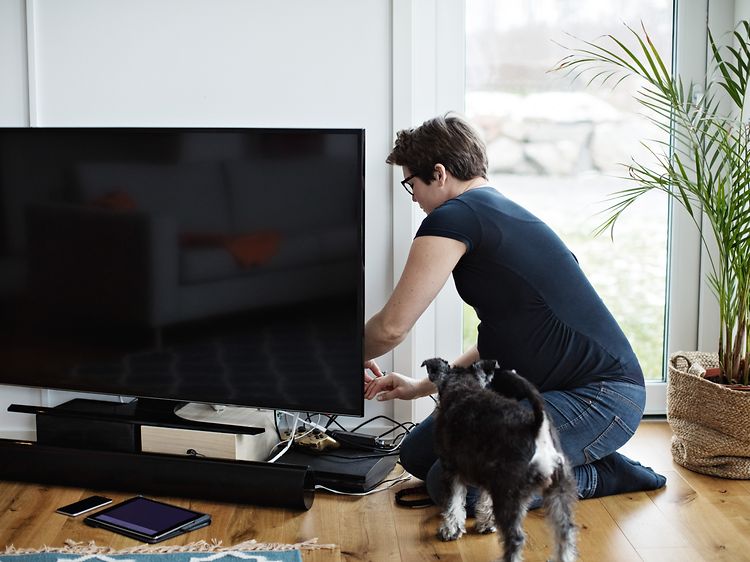 Woman checking a TV