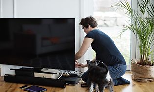 Woman checking a TV