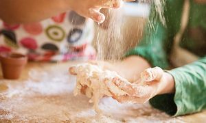 Hands that work with flour on a kitchen counter