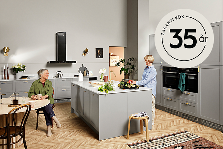 Two women in an Epoq kitchen and a 35-year warranty logo