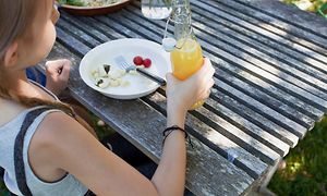 Cross category Summer -Girl holding cold soda in a garden-min