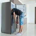SDA-Cooling-Man putting head in a fridge freezer-min