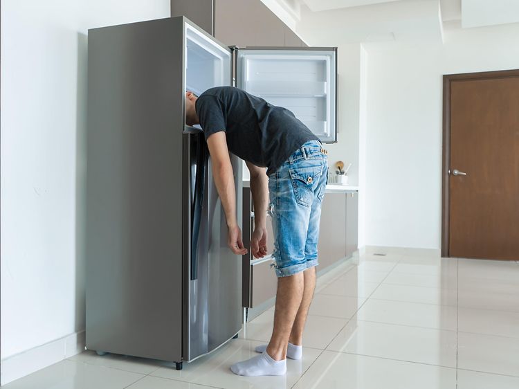 SDA-Cooling-Man putting head in a fridge freezer-min