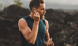 Brown goods -Earbuds - Man running outside with earbuds-min