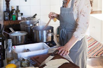 SDA-Cooking-Woman preparing dinner in a kitchen
