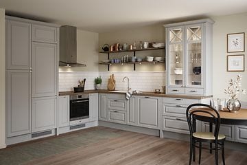 Full Heritage Light Grey kitchen with glass cabinet, laminate Medusa Brown wooden worktop and a dining table