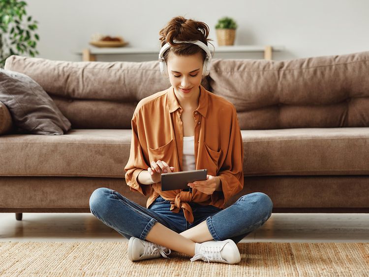 Woman sitting on floor using a tablet