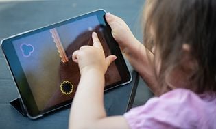 Younger girl playing on a tablet