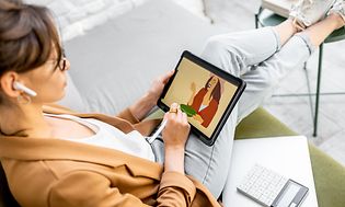 Female artist drawing on a tablet with a pen