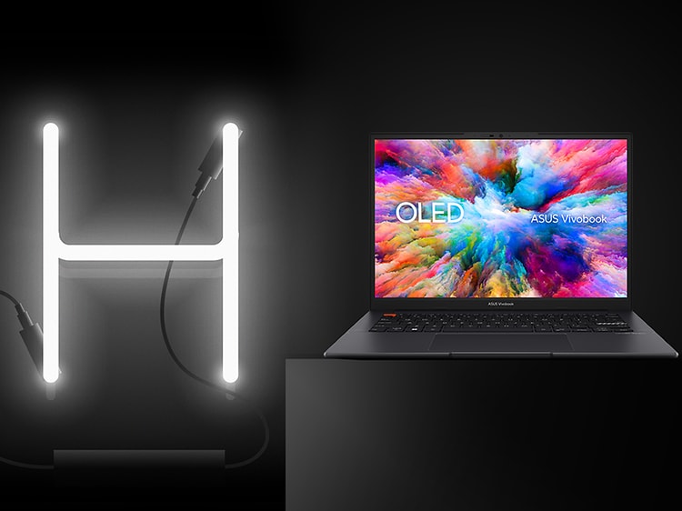 Vivobook S14 OLED med en färgexplosion på skärmen i ett mörkt rum med en skarp LED-belysning bredvid som är formad som ett H